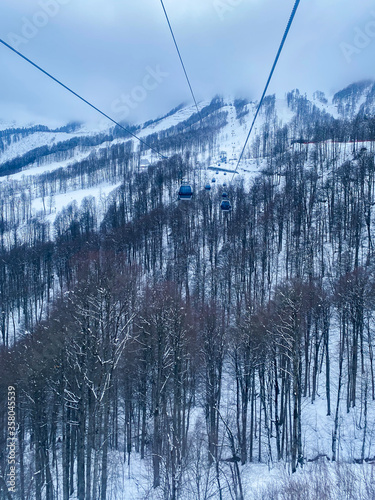 Funicular cabins on a background of a winter landscape