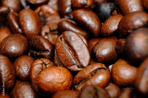 Blurred coffee beans on wood table and macro coffee beans background