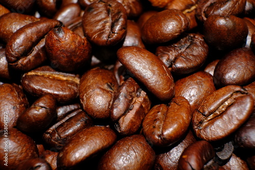 Blurred coffee beans on wood table and macro coffee beans background