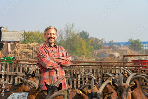 Smiling Farmer With Goats at His Organic Goat Dairy Farm