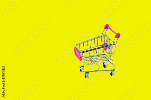 market shopping hand cart isolated on yellow background
