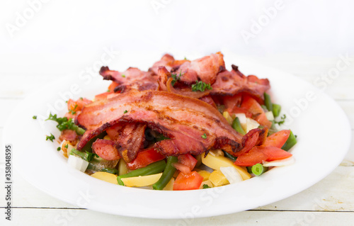 Salad with bacon front view close up