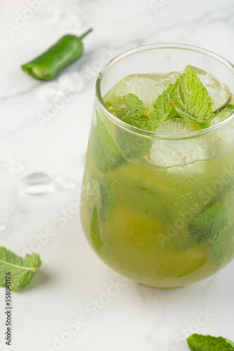 green drink with ice and mint close-up.