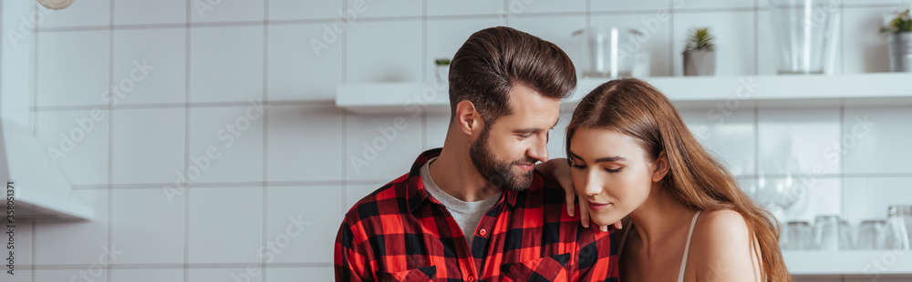 panoramic shot of happy young couple in kitchen panoramic shot of happy young couple in kitchen