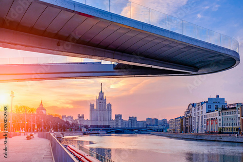 Canvas Print Morning city landscape with view on soaring bridge in Zaryadye park and moscow river embankment with skyscraper on background
