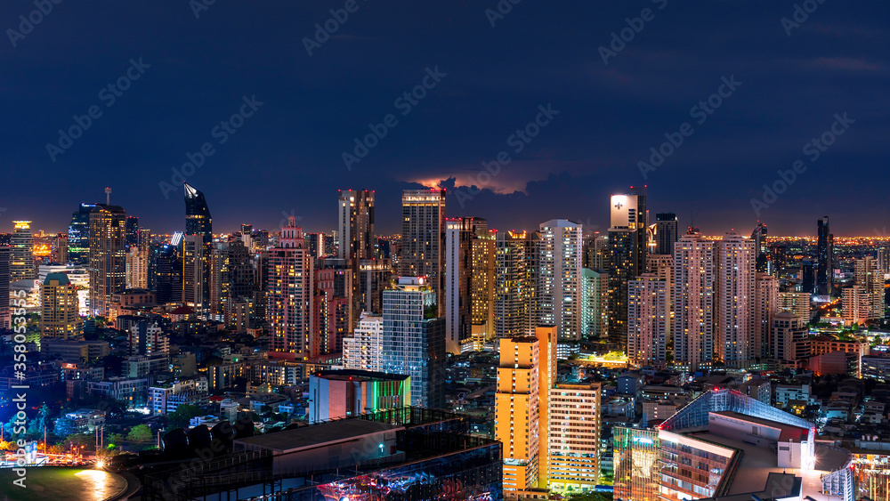 Night City scape of Bangkok central with Lightning and cloudy background
