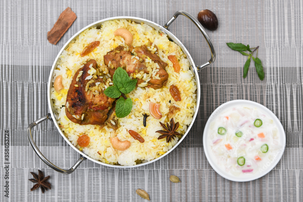Top view of Bombay biryani, Traditional spicy indian food, Iftar meal, Chicken rice Ramadan dinner on white background. Top view of Bombay biryani, Traditional spicy indian food, Iftar meal, Chicken rice Ramadan dinner on white background.