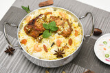 Top view of Bombay biryani, Traditional spicy indian food, Iftar meal, Chicken rice Ramadan dinner on white background.