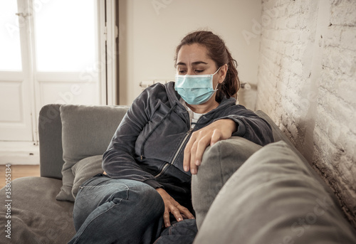 Lonely woman suffering from depression at home during coronavirus lockdown and social distancing