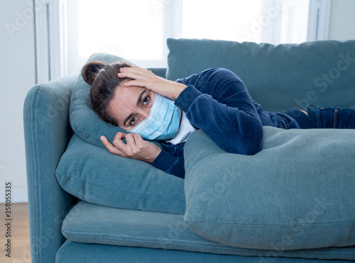 Lonely woman suffering from depression at home during coronavirus lockdown and social distancing