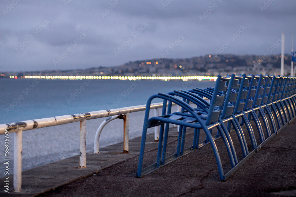 Obraz premium French Riviera landscape from Promenade des Anglais with blue chairs in Nice, France