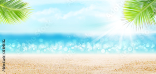 Summer tropical sea with sparkling waves, sand and blue sunny sky