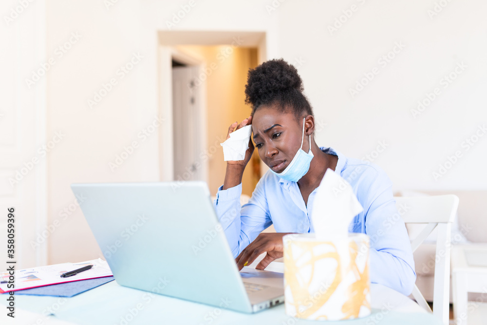 I can not believe I caught a cold! Frustrated african american businesswoman using a tissue to sneeze in while being seated in the office. It's flu season. Sick young business woman at work I can not believe I caught a cold! Frustrated african american businesswoman using a tissue to sneeze in while being seated in the office. It's flu season. Sick young business woman at work