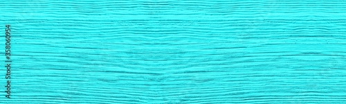 Wide old cracked bright turquoise painted wooden surface. Light teal colored wood texture. Rustic vintage background
