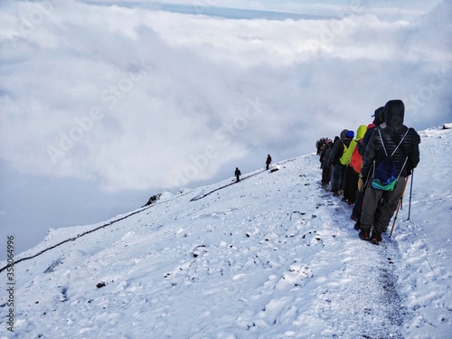 Wan, India - June 2nd 2018: Climbing down from top of the mighty Himalayan Mountain with epic view and a circular Rainbow photo