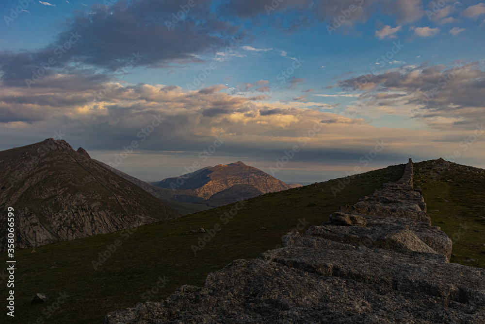 Naklejka premium Late evening sunlight catching Slieve Binnian, Mourne Mountains, County Down, Northern Ireland, Mourne Area of Outstanding Natural Beauty
