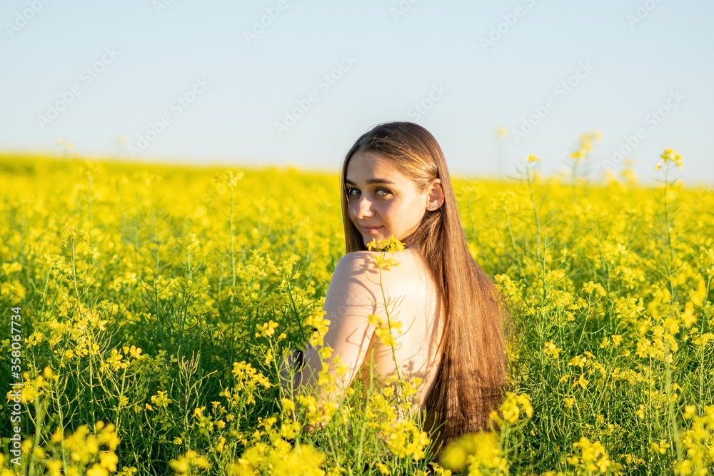 Beautiful girl in a rapeseed field, with an open shoulder. Beautiful girl in a rapeseed field, with an open shoulder.