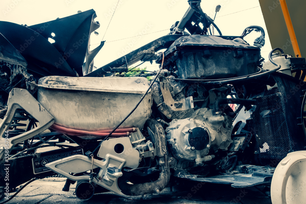 Vehicle, tricycle, after an accident. A burned motorcycle near the ...
