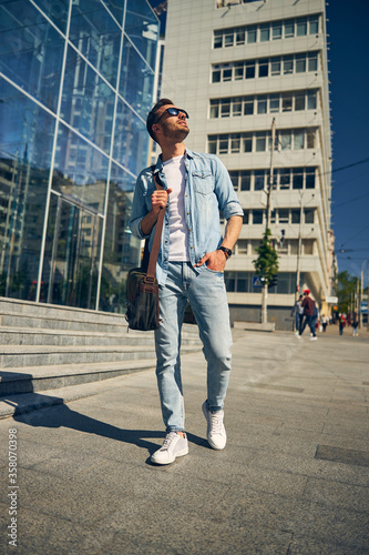 Delighted freelancer walking in the city center © Svitlana