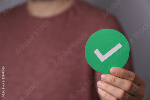 hand holding green checkmark