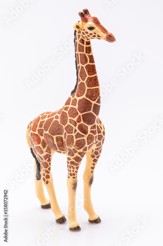 close up of a giraffe made from plastic isolated on a white background