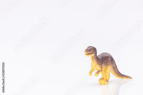 close-up of a colorfull plastic dinosaur figurine isolated on a white background