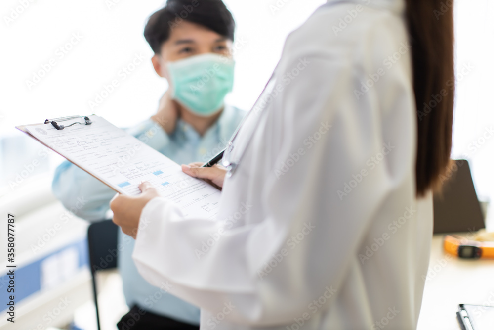 Medicine and health care concept. Asian woman doctor is taking care patient in hospital.doctor or nurse wear protection mask checking and takecare infection people from covid-19 . Medicine and health care concept. Asian woman doctor is taking care patient in hospital.doctor or nurse wear protection mask checking and takecare infection people from covid-19 .