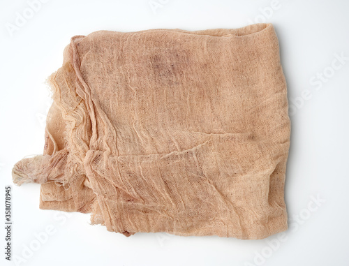 Valokuva folded beige cotton gauze kitchen napkin on a white background