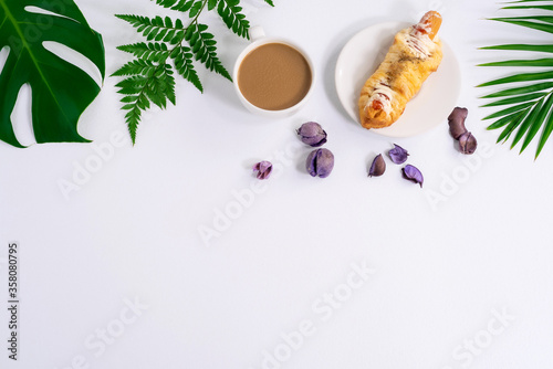 Top view of fresh bread and coffee,Fern leaf,monstera leaf, separate on a white background wood