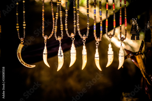 close up of tooth necklace at market photo