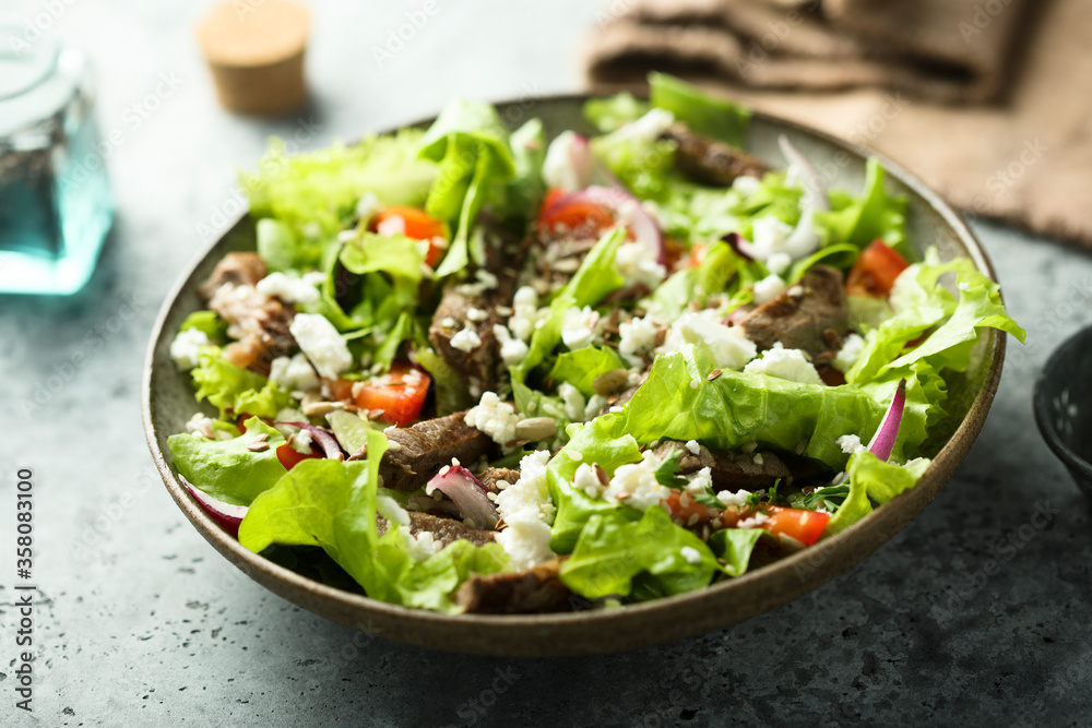 Green salad with beef steak and fresh cheese Green salad with beef steak and fresh cheese