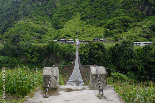 Long suspension bridge to Ngadi. Bridge across Marsyangdi river on the Annapurna circuit. photo