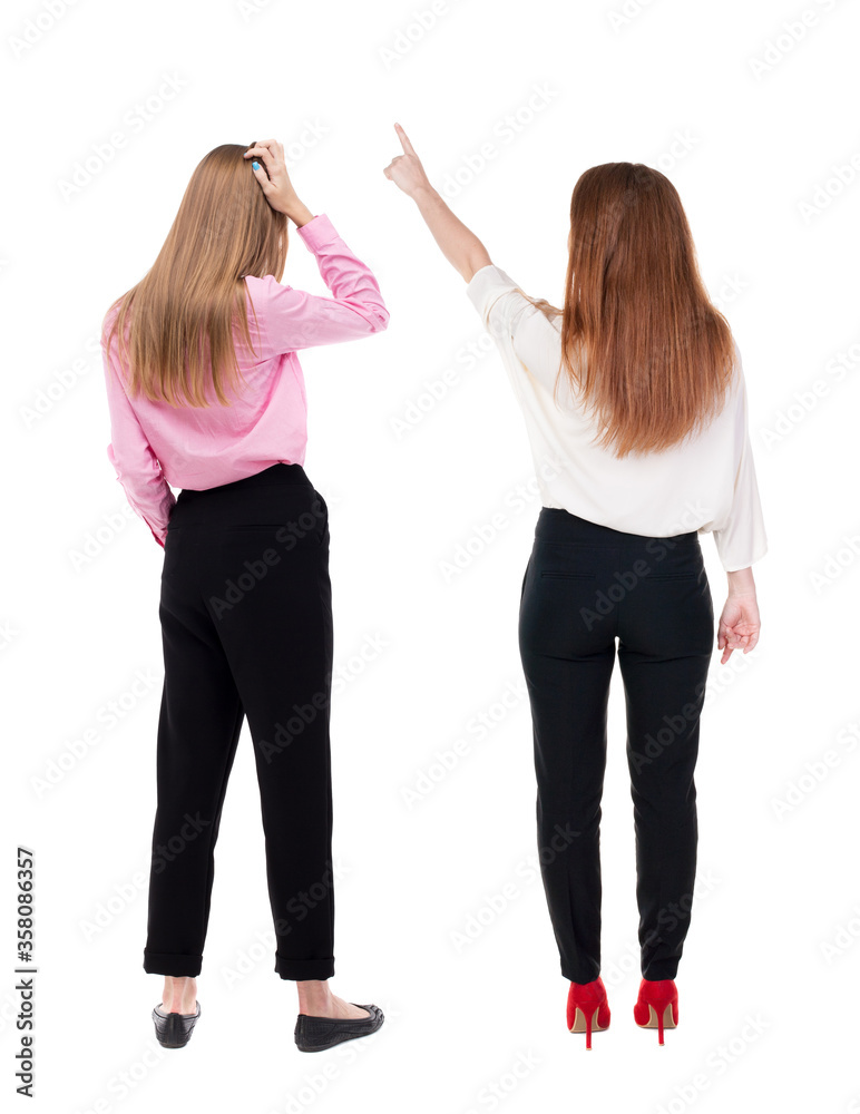 Back view of two business woman in suit pointing. Back view of two business woman in suit pointing.