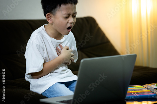 фотографія Sick asian kid boy with chest pain suffering from heart attack,ill little child