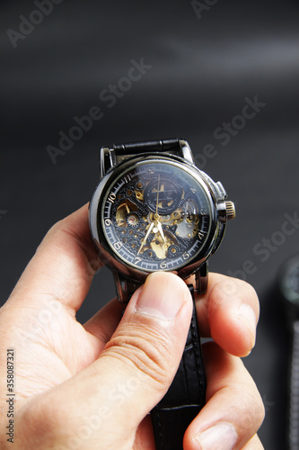 Wallpaper Mural Black automatic self winding wristwatch with transparent sekeleton dial design on black leather background Torontodigital.ca