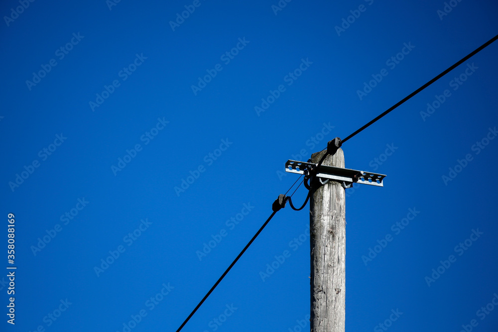 old wooden electric pole against blue sky old wooden electric pole against blue sky