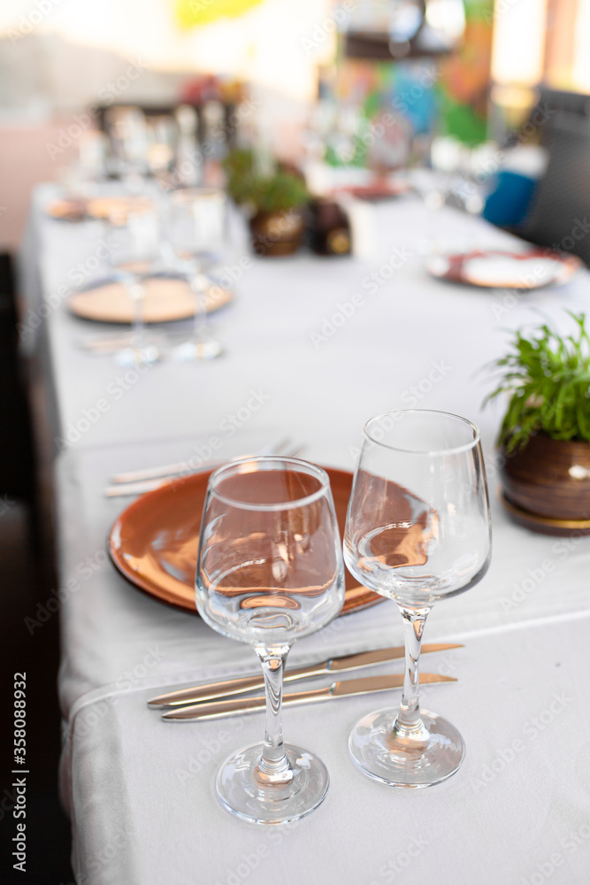 Stylish table setting in an open-air restaurant. Stylish table setting in an open-air restaurant.