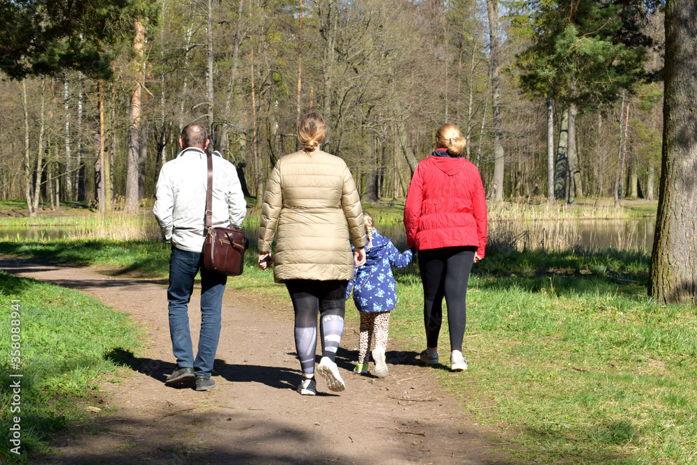 Fototapeta premium family walking in the park