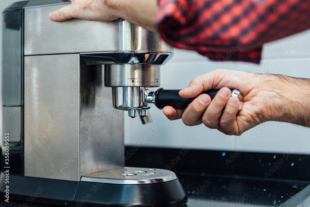 Detail of man's hands preparing an espresso Detail of man's hands preparing an espresso