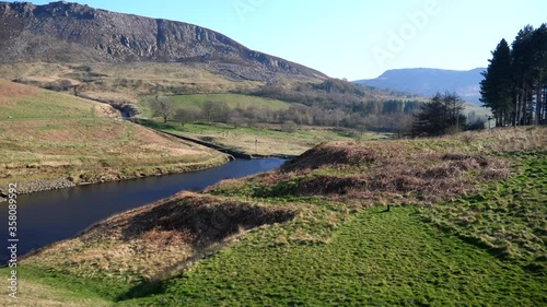 View toward Dovestone reservoir from Yeoman Hey dam, Yeoman Hey reservoir bypass or by pas water chute seen joining Dove stone reservoir. photo