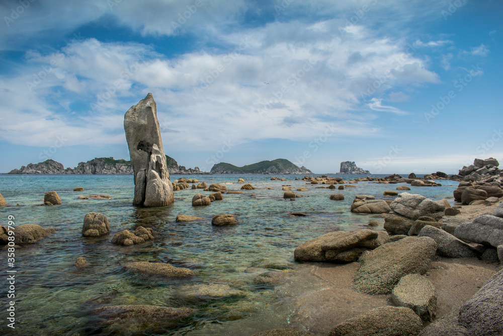 Fototapeta premium Large stones in the sea with a transparent bottom
