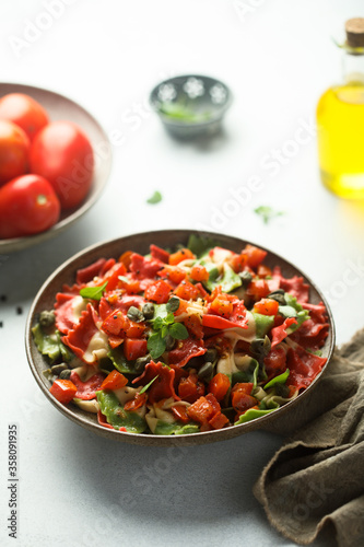 Multi-colored Italian pasta with capers and tomatoes