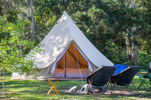 Stampa su tela Glamping camping teepee tent and chairs at the campsite