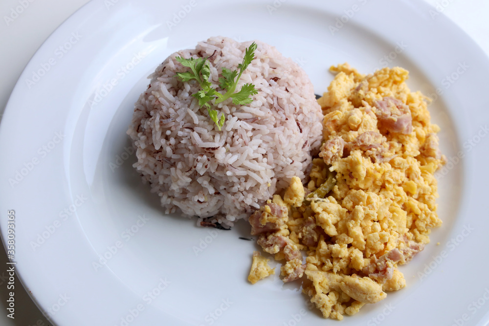 Riceberry with omelette served in a white round dish Put on the white table Ready to eat Riceberry with omelette served in a white round dish Put on the white table Ready to eat