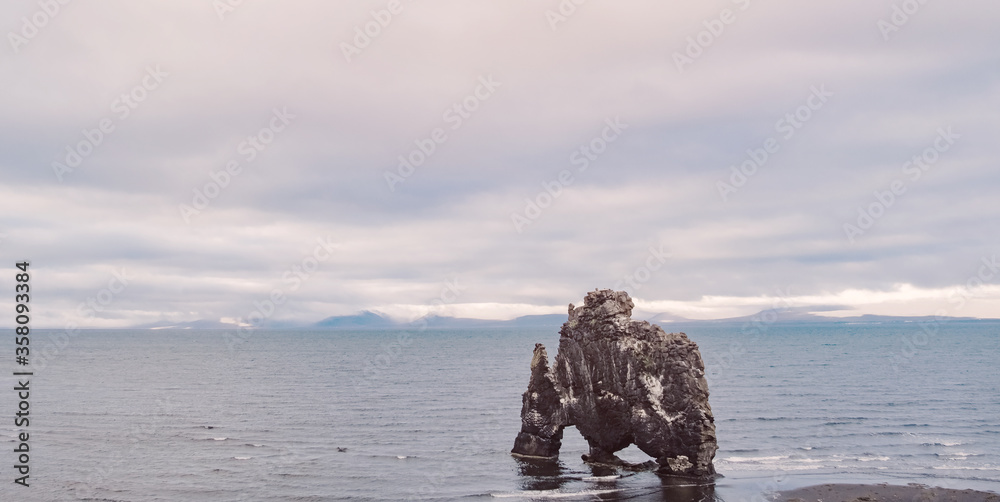 Hvitserkur basalt mountain rock on the east coast in Iceland. Peninsula Vatnsnes. Beautiful nature scandian landscape. Travel icelandic destination. Postcard concept. Hvitserkur basalt mountain rock on the east coast in Iceland. Peninsula Vatnsnes. Beautiful nature scandian landscape. Travel icelandic destination. Postcard concept.