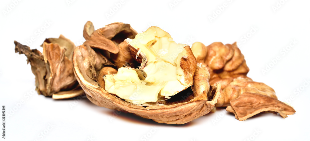 Crushed walnuts with nutshell isolated on white background Crushed walnuts with nutshell isolated on white background