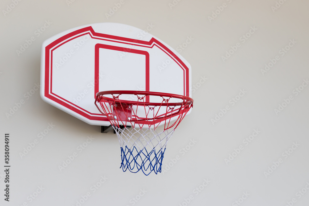 plastic basketball hoop on white concrete wall. sport equipment toy for kid.