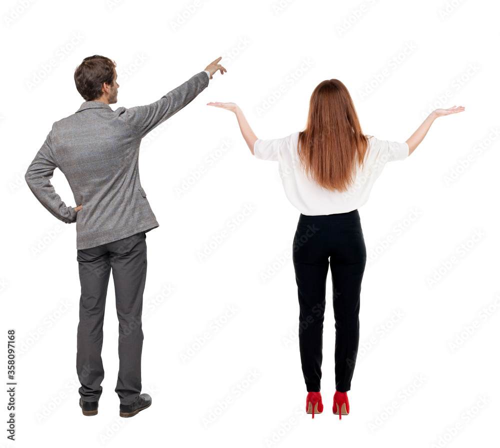 Back view of business man and business woman in suit pointing. Back view of business man and business woman in suit pointing.