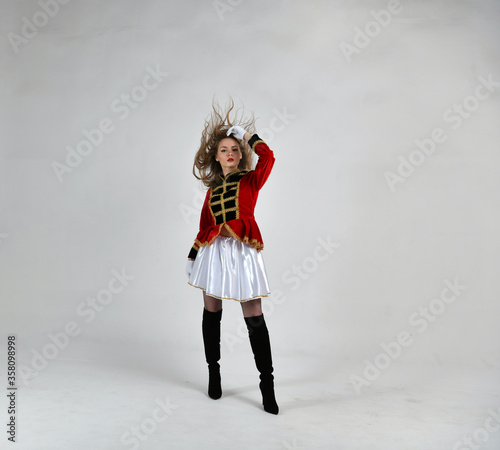 beautiful girl in red hussar uniform with loose hair