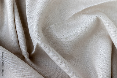 Natural linen fabric texture. Rough crumpled burlap background. Selective focus. Closeup view